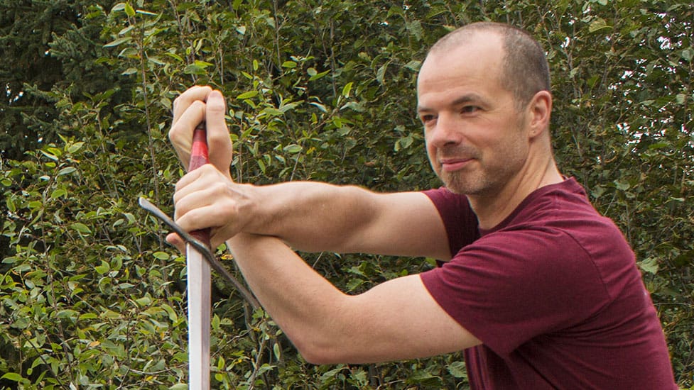 Greg Reimer demonstrating swordplay outdoors